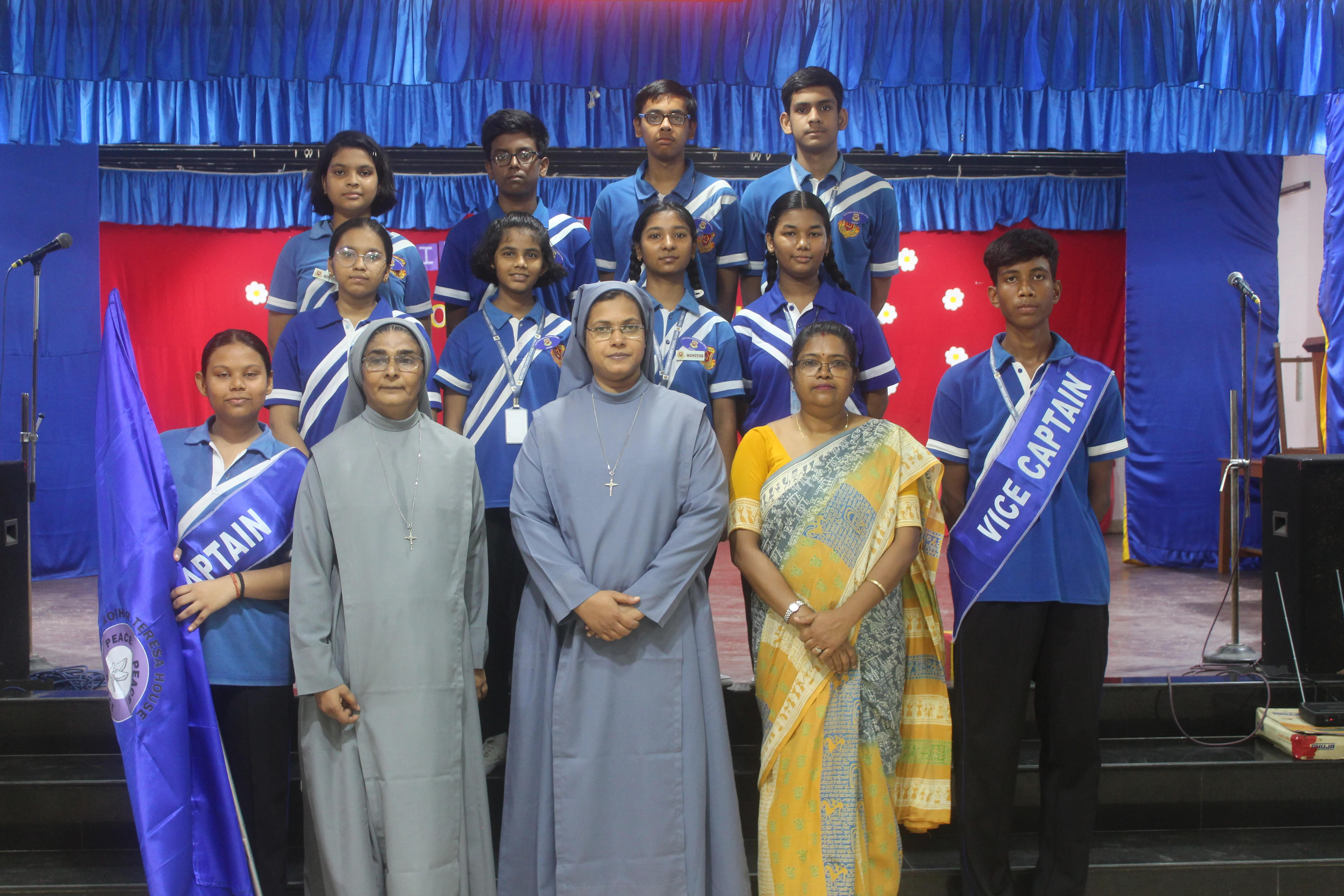 Principal addressing students at Investiture Ceremony Holy Family Convent School